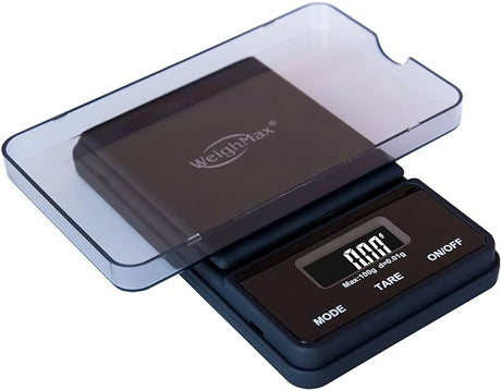 Front angled view of the Weighmax Ninja digital scale in sleek black. This portable pocket scale features high-precision weighing capabilities, a backlit LCD display, and a stainless steel platform for accurately measuring botanical herbs and concentrates.