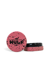 Front angled view of the Wulf Mods 2-Piece 50mm Spatter Aluminum Grinder in pink with black paint splatter. This ultra-compact, travel-friendly magnetic herb grinder features a streamlined two-piece design to quickly and efficiently shred your botanical blends without any extra bulk.