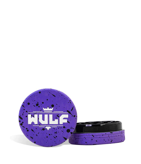 Front angled view of the Wulf Mods 2-Piece 50mm Spatter Aluminum Grinder in purple with black paint splatter. This ultra-compact, travel-friendly magnetic herb grinder features a streamlined two-piece design to quickly and efficiently shred your botanical blends without any extra bulk.