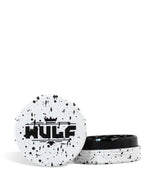 Front angled view of the Wulf Mods 2-Piece 65mm Spatter Aluminum Grinder in white with black paint splatter. This compact, travel-friendly magnetic herb grinder features a streamlined two-piece design to quickly and efficiently shred your botanical blends without added bulk.