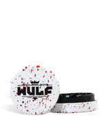 Front angled view of the Wulf Mods 2-Piece 65mm Spatter Aluminum Grinder in white with vibrant red paint splatter. This compact, travel-friendly magnetic herb grinder features a streamlined two-piece design to quickly and efficiently shred your botanical blends without added bulk.