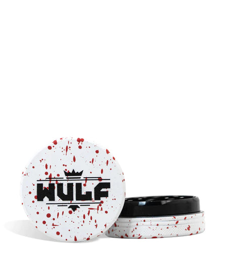 Front angled view of the Wulf Mods 2-Piece 65mm Spatter Aluminum Grinder in white with vibrant red paint splatter. This compact, travel-friendly magnetic herb grinder features a streamlined two-piece design to quickly and efficiently shred your botanical blends without added bulk.