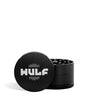 Front angled view of the Wulf Mods 4-Piece 65mm Aluminum Grinder in sleek matte black with a white logo. Crafted from heavy-duty aluminum, this multi-chamber grinder effortlessly shreds dry botanicals to the perfect fluffy consistency for rolling or packing.